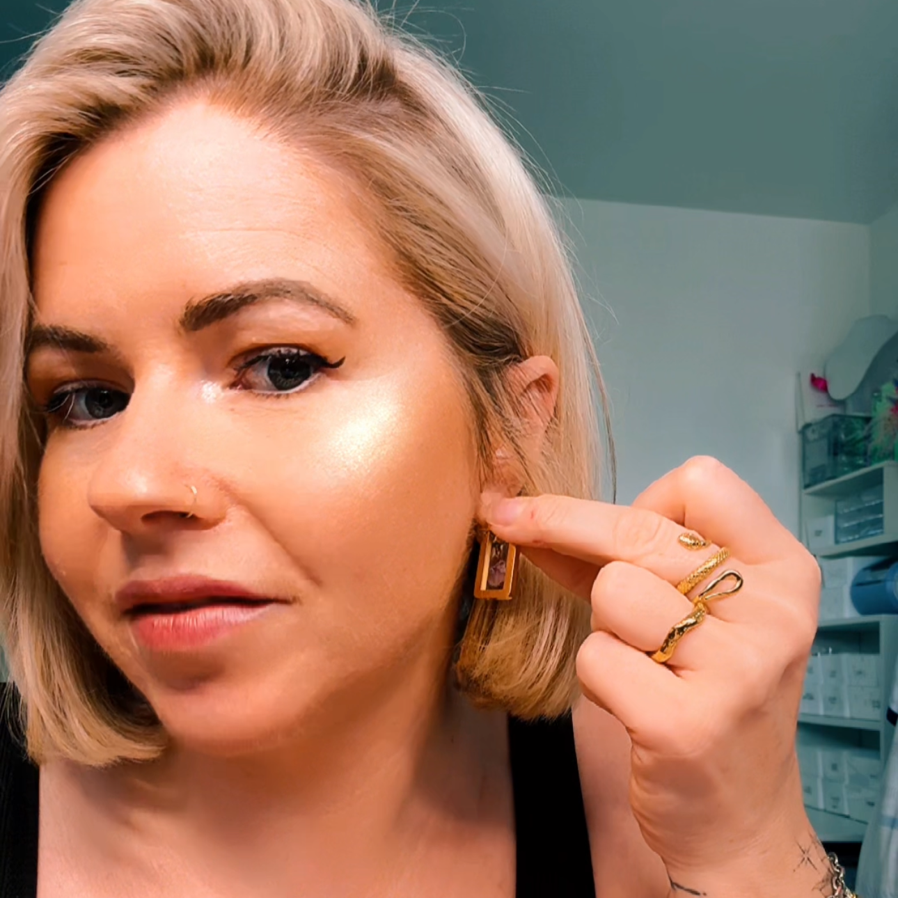 Woman pointing to gold rectangle hoops | gold hoop earrings
